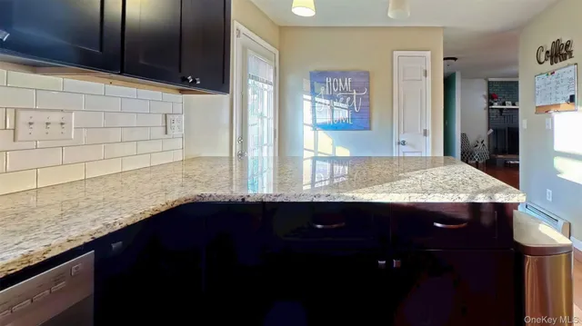 a kitchen with stainless steel appliances granite countertop a sink stove and microwave