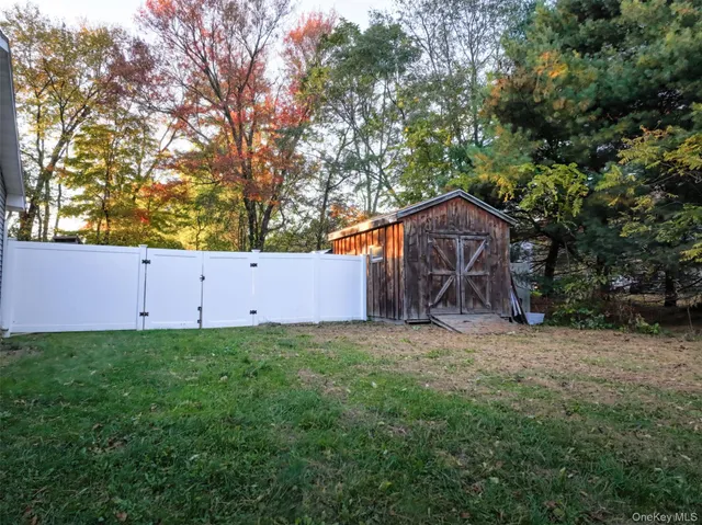 a view of a backyard with sitting area and garden