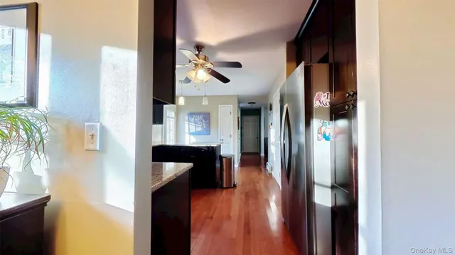 a sink with granite countertop cabinets and black appliances