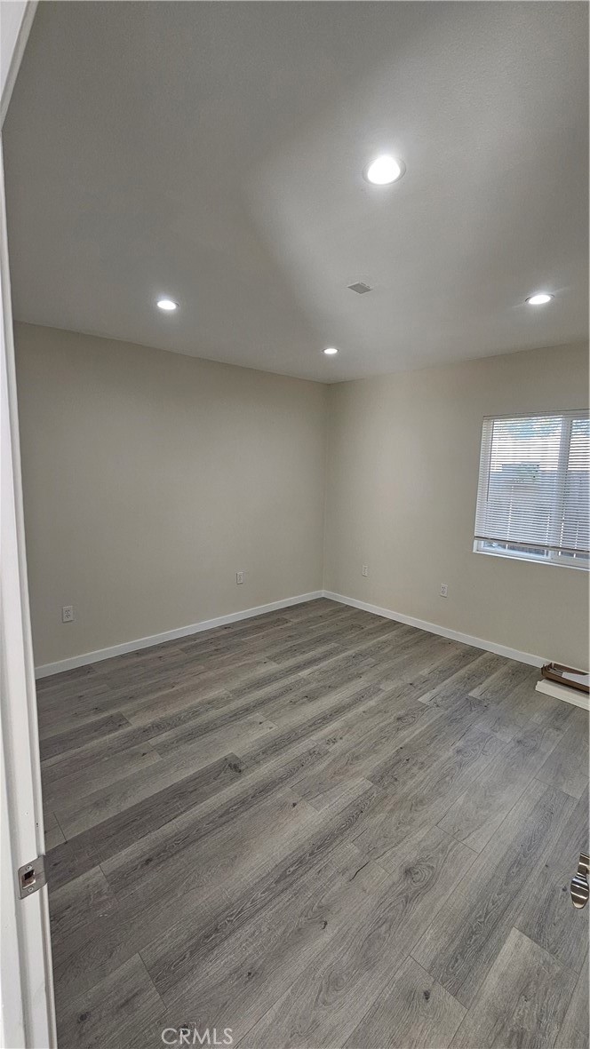 1344 Hardt Street San Bernardino, CA 92408 - Photo 11 of 12 an empty room with wooden floor and windows