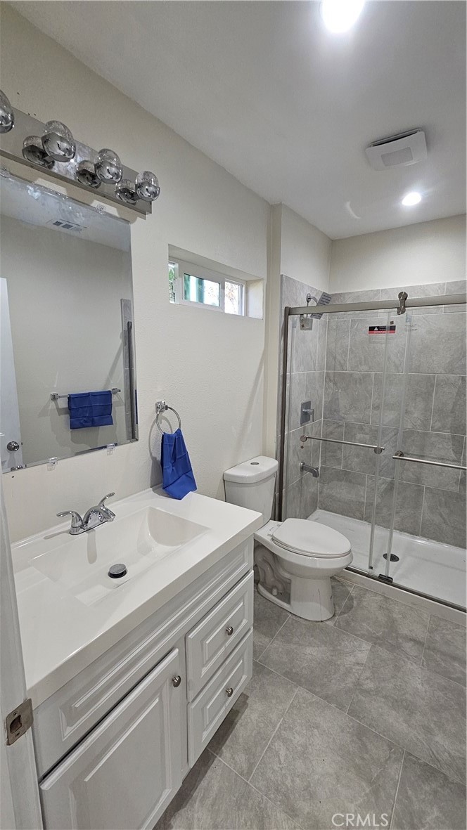 1344 Hardt Street San Bernardino, CA 92408 - Photo 9 of 12 a bathroom with a sink a toilet and shower