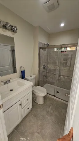 a bathroom with a double vanity sink toilet and shower