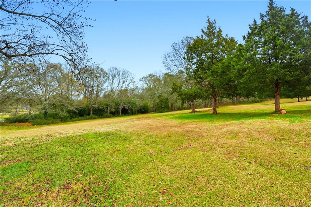 1295 Double Bridges Road Winder, GA 30680 - Photo 32 of 57 a view of field with trees in the background