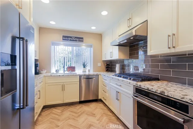 a kitchen with stainless steel appliances granite countertop a stove and a sink
