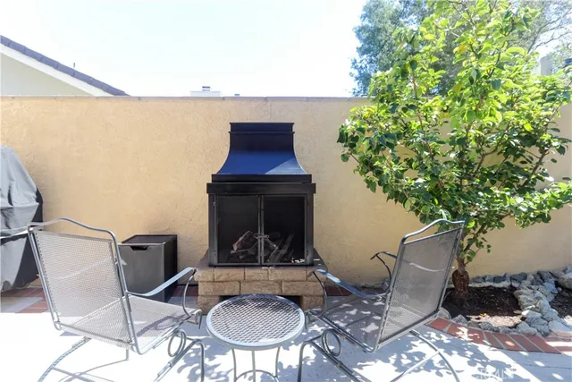 a outdoor living space with furniture potted plant and a large window