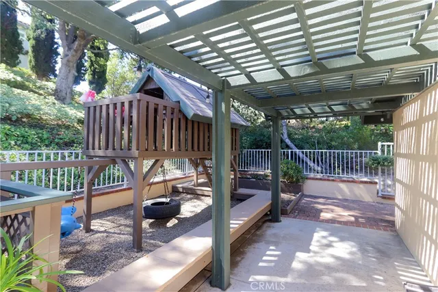 an aerial view of a house with a yard and large trees