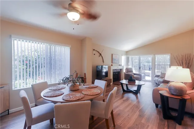 a dining room with furniture window and wooden floor