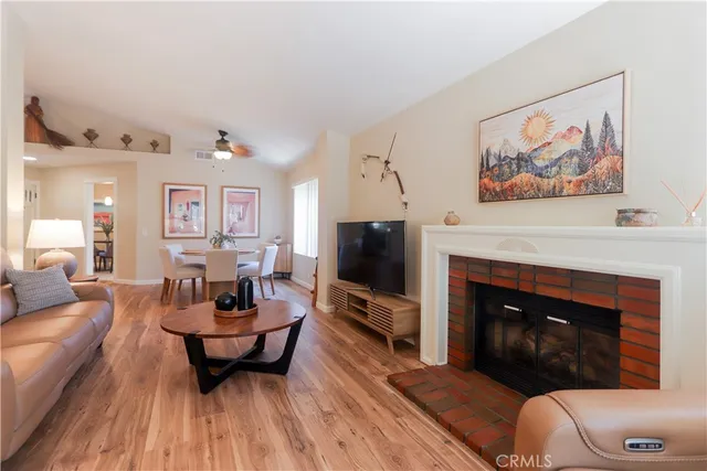 a living room with furniture a flat screen tv and a fireplace