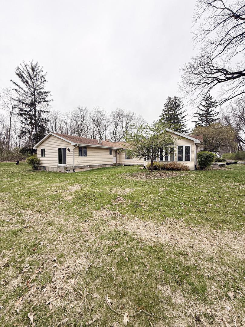 1599 East 2700 North Road Clifton, IL 60927 - Photo 1 of 26 a view of a house with a big yard and large trees