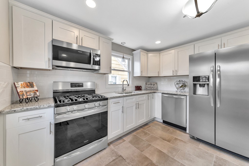 63 Haskin Street Springfield, MA 01109 - Photo 1 of 27 a kitchen with white cabinets stainless steel appliances and a sink