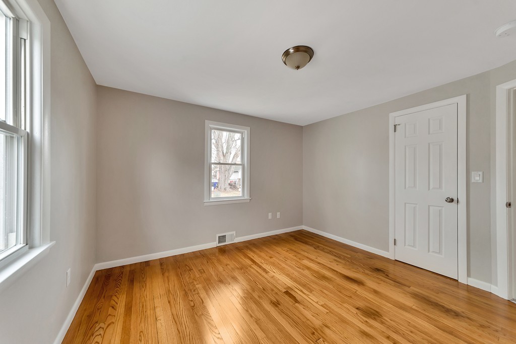 63 Haskin Street Springfield, MA 01109 - Photo 12 of 27 a view of empty room with wooden floor and fan