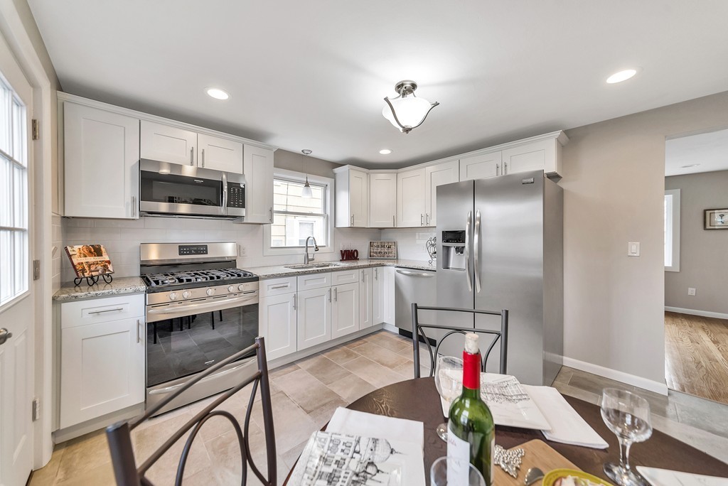63 Haskin Street Springfield, MA 01109 - Photo 4 of 27 a kitchen with stainless steel appliances granite countertop a stove refrigerator sink and cabinets