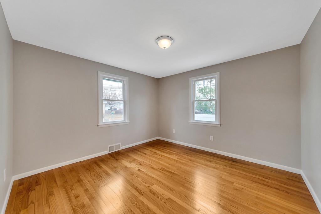 63 Haskin Street Springfield, MA 01109 - Photo 10 of 27 a view of an empty room with wooden floor and a window