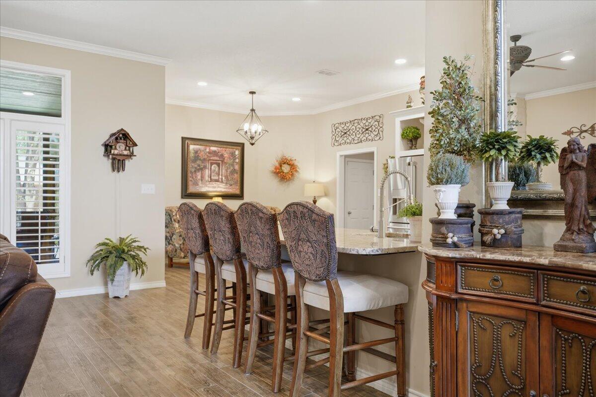 4612 100th Street Lubbock, TX 79424 - Photo 15 of 55 a view of a dining room with furniture and a potted plant