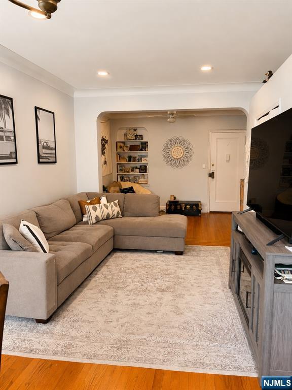 100 Prospect Avenue, Unit 5H Hackensack, NJ 07601 - Photo 6 of 17 a living room with furniture and a flat screen tv