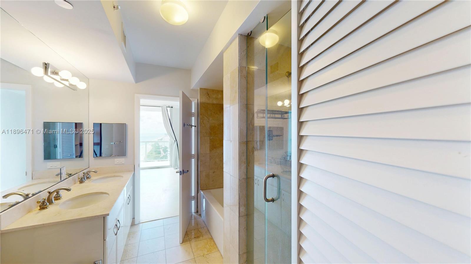 6365 Collins Avenue, Unit 2904 Miami Beach, FL 33141 - Photo 15 of 28 a bathroom with a sink and a mirror