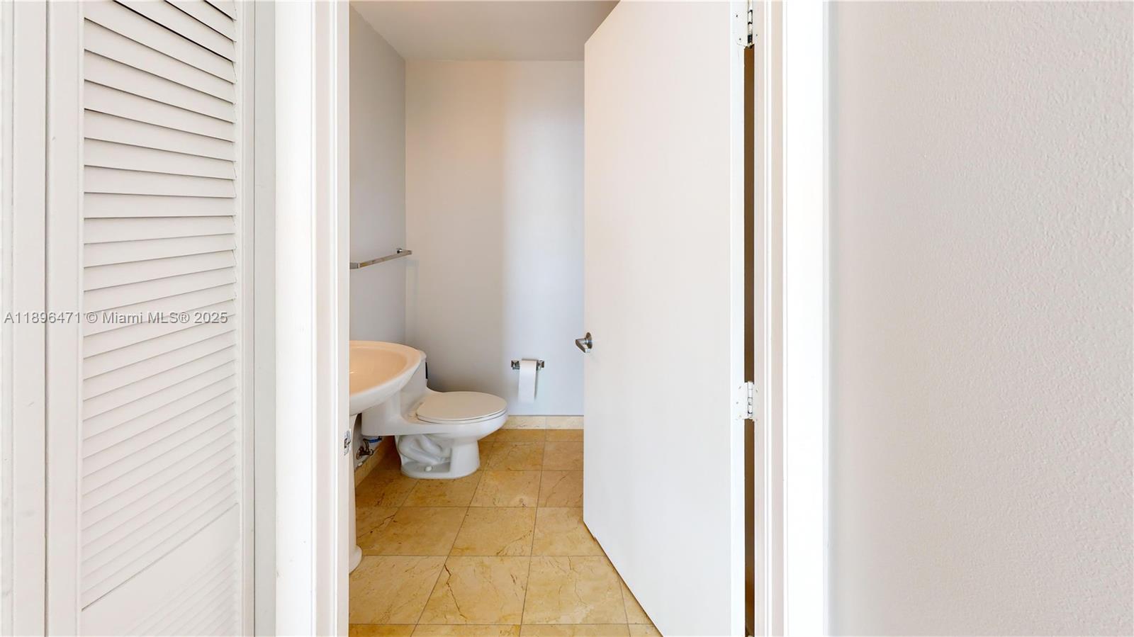 6365 Collins Avenue, Unit 2904 Miami Beach, FL 33141 - Photo 20 of 28 a bathroom with a sink and a toilet