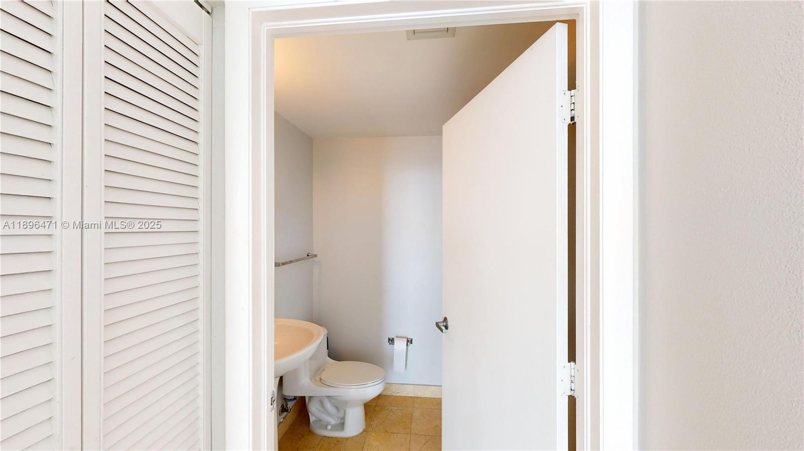 6365 Collins Avenue, Unit 2904 Miami Beach, FL 33141 - Photo 5 of 28 a bathroom with a toilet and a shower