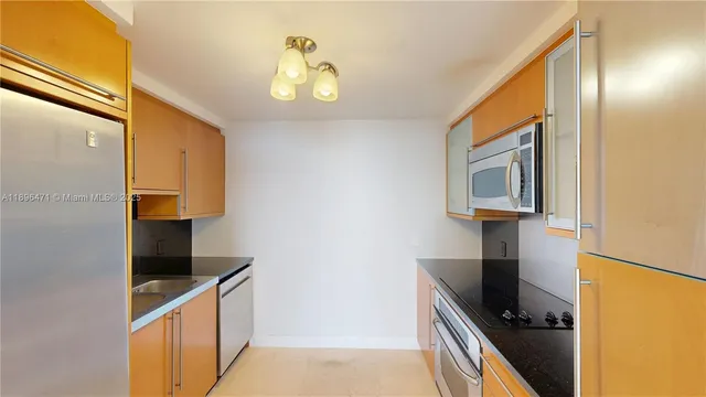 a kitchen with a sink and a refrigerator