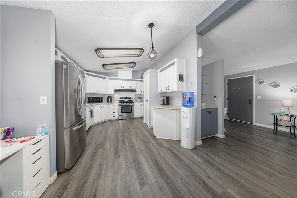 4080 Pedley Road, Unit 53 Jurupa Valley, CA 92509 - Photo 19 of 41 a kitchen with stainless steel appliances a refrigerator and wooden floor