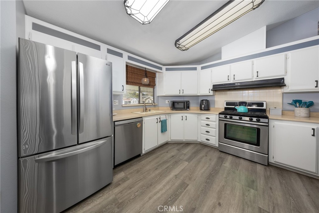 4080 Pedley Road, Unit 53 Jurupa Valley, CA 92509 - Photo 21 of 41 a kitchen with stainless steel appliances a refrigerator sink and cabinets