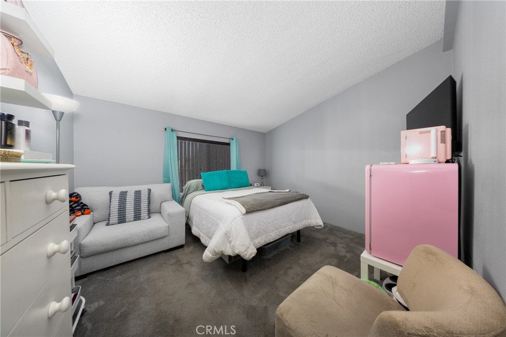 4080 Pedley Road, Unit 53 Jurupa Valley, CA 92509 - Photo 22 of 41 a spacious bedroom with a bed and a couch