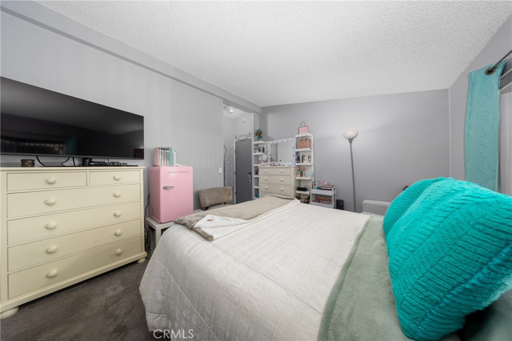 4080 Pedley Road, Unit 53 Jurupa Valley, CA 92509 - Photo 23 of 41 a bedroom with a bed and flat screen tv