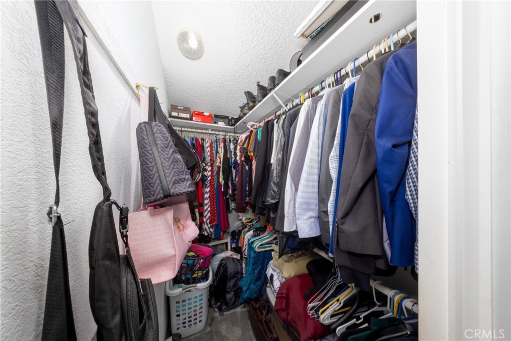 4080 Pedley Road, Unit 53 Jurupa Valley, CA 92509 - Photo 24 of 41 a view of walk in closet with clothes and shoes