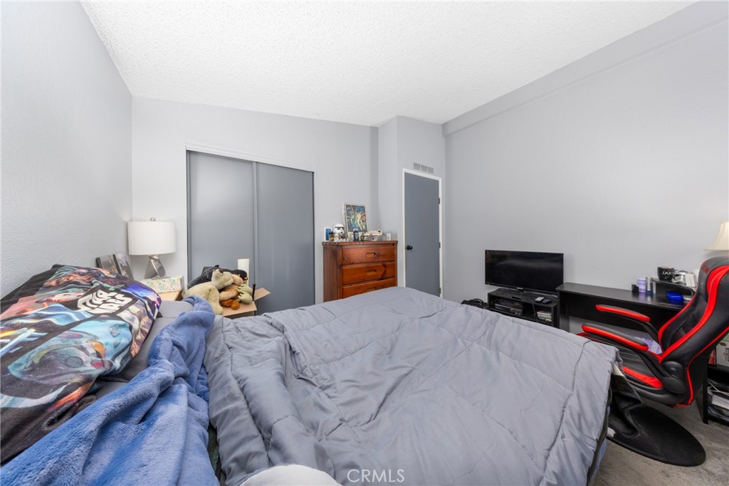 4080 Pedley Road, Unit 53 Jurupa Valley, CA 92509 - Photo 30 of 41 a bedroom with a bed and wooden floor