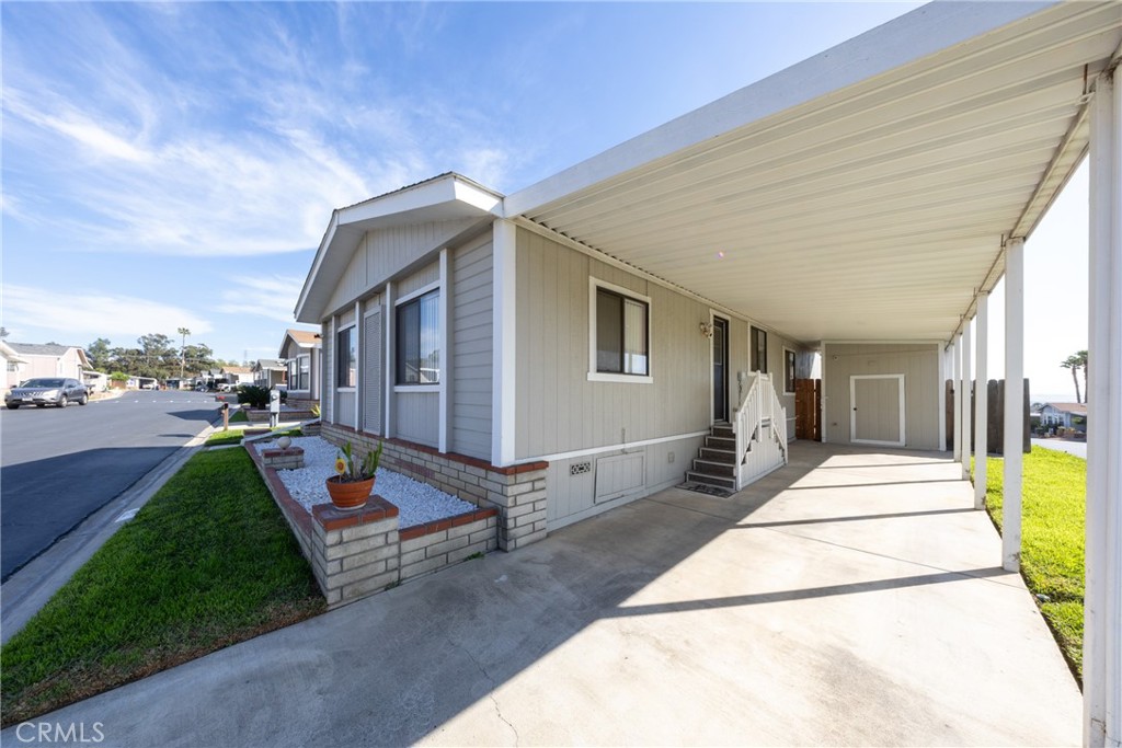 4080 Pedley Road, Unit 53 Jurupa Valley, CA 92509 - Photo 3 of 41 a front view of a house with a garden and trees