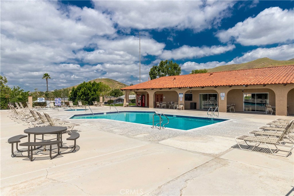 4080 Pedley Road, Unit 53 Jurupa Valley, CA 92509 - Photo 38 of 41 a swimming pool with outdoor seating and barbeque oven