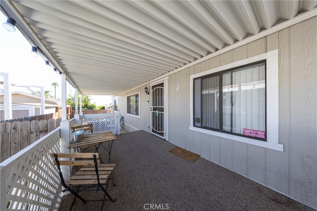 4080 Pedley Road, Unit 53 Jurupa Valley, CA 92509 - Photo 8 of 41 a view of a porch with furniture and floor to ceiling window