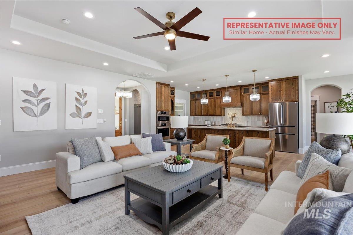 1513 Lavender Rupert, ID 83350 - Photo 2 of 16 Living room with arched walkways, recessed lighting, a ceiling fan, and light wood-style flooring