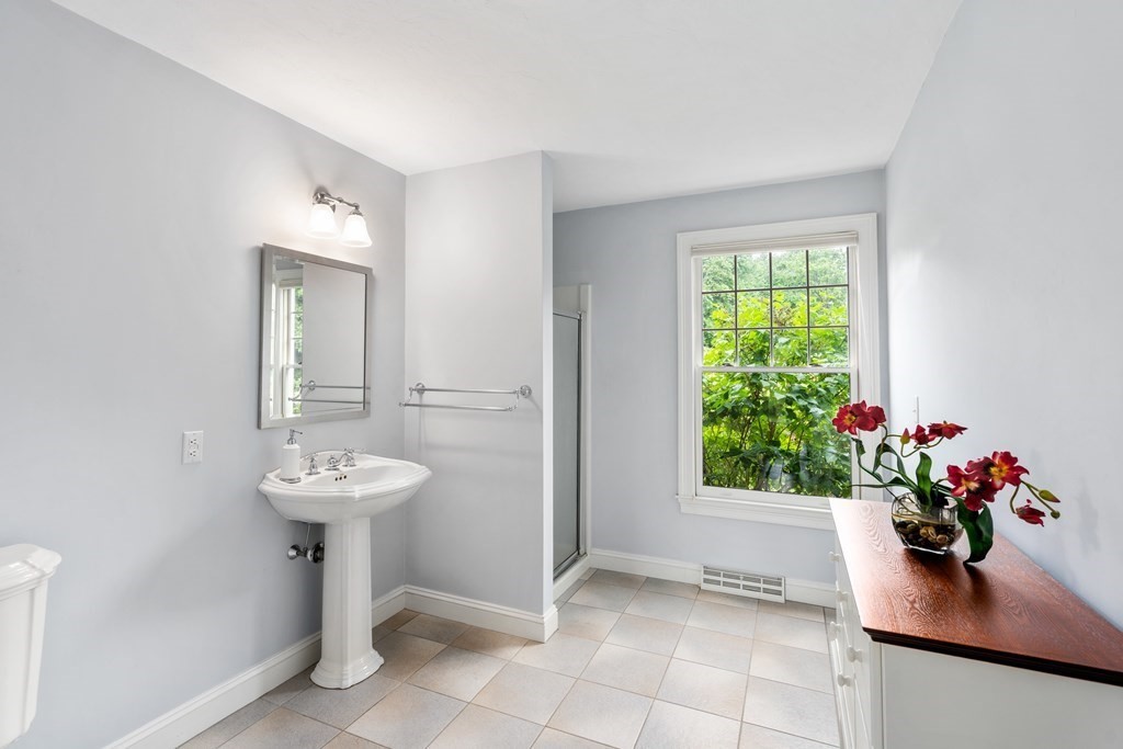 181 Maple Street Sherborn, MA 01770 - Photo 21 of 41 a room with a sink mirror and window