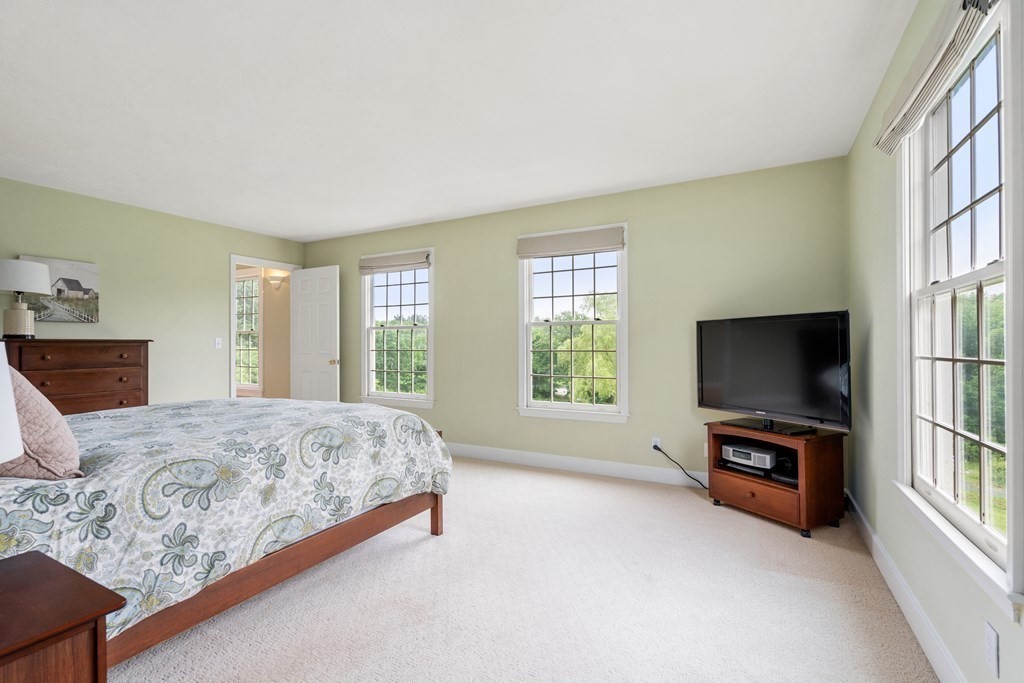 181 Maple Street Sherborn, MA 01770 - Photo 24 of 41 a bedroom with a bed and a flat screen tv