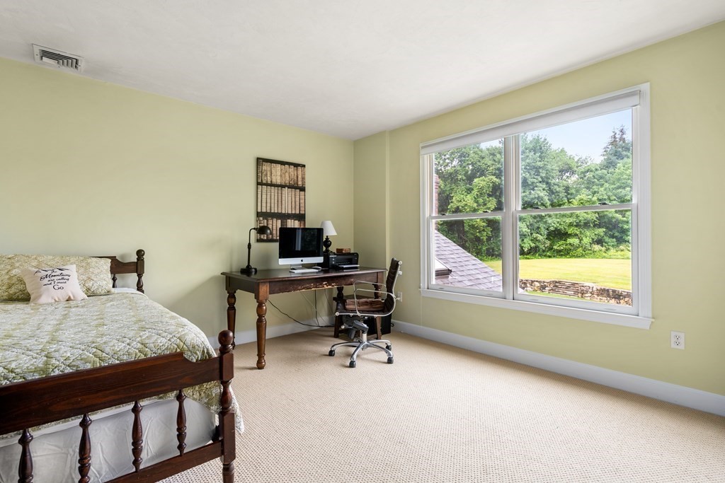 181 Maple Street Sherborn, MA 01770 - Photo 28 of 41 a bedroom with a bed and a desk