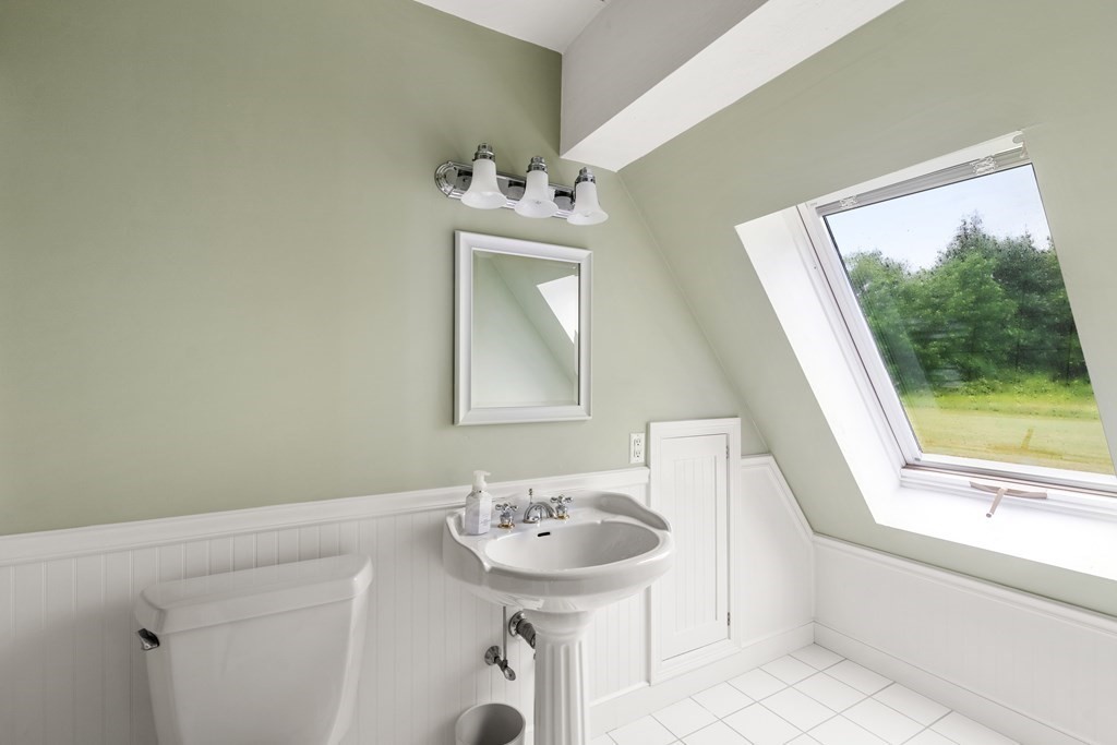 181 Maple Street Sherborn, MA 01770 - Photo 35 of 41 a bathroom with a sink a mirror and a window
