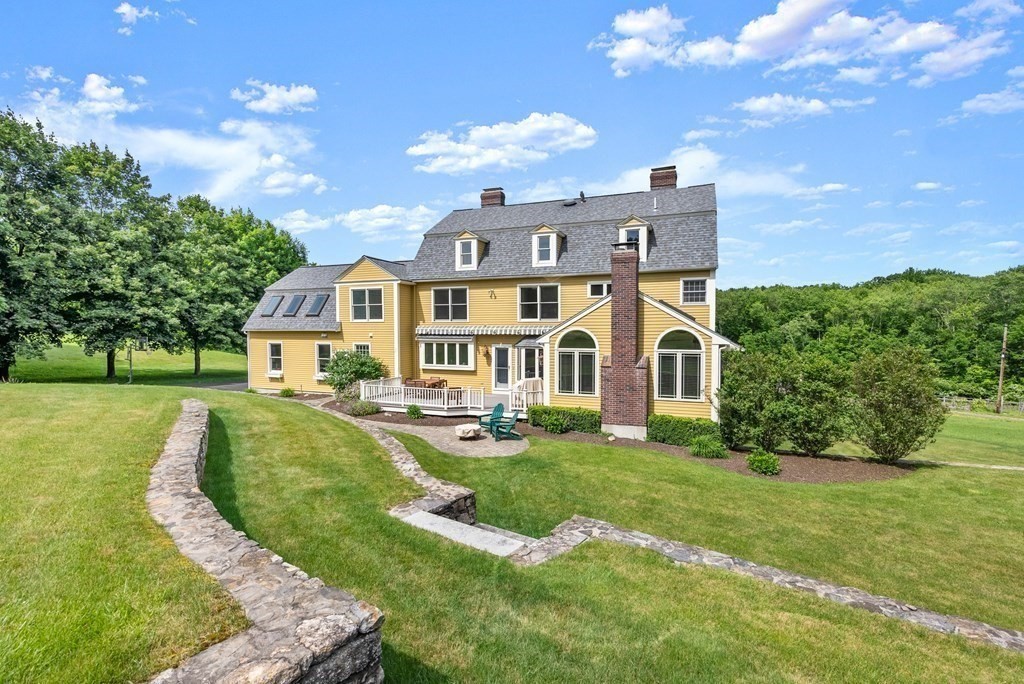 181 Maple Street Sherborn, MA 01770 - Photo 39 of 41 a view of a house with a big yard and potted plants