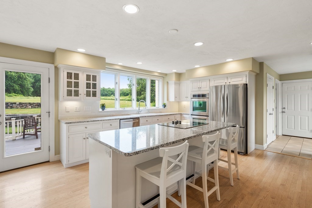 181 Maple Street Sherborn, MA 01770 - Photo 10 of 41 a kitchen with stainless steel appliances granite countertop a stove and a refrigerator