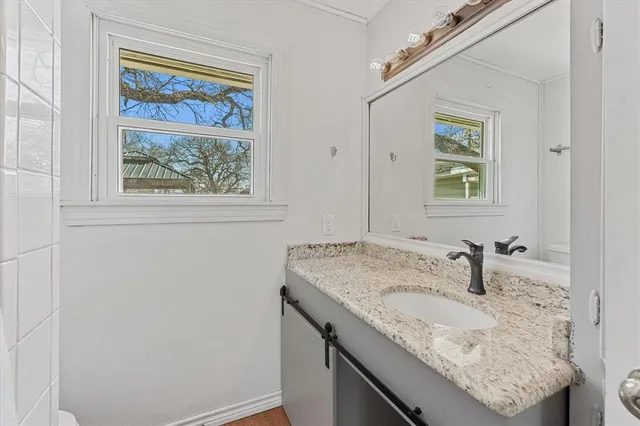 a bathroom with a sink and mirror