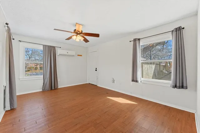 wooden floor in an empty room with a window