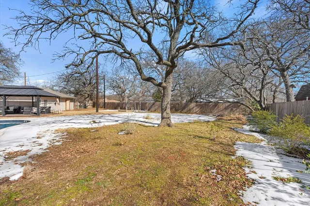 a view of a yard with snow on the road