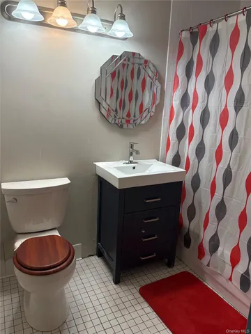 a bathroom with a toilet a sink and a mirror