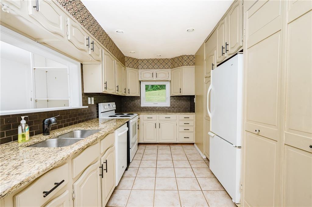 145 Hood School Road Indiana, PA 15701 - Photo 41 of 46 a kitchen with stainless steel appliances a refrigerator sink and cabinets