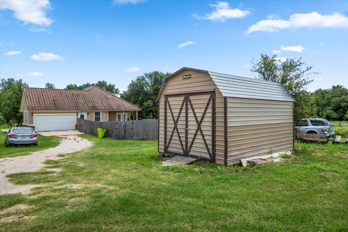437 Balch Road Elgin, TX 78621 - Photo 30 of 37 Featuring a detached shed for additional storage and functionality.