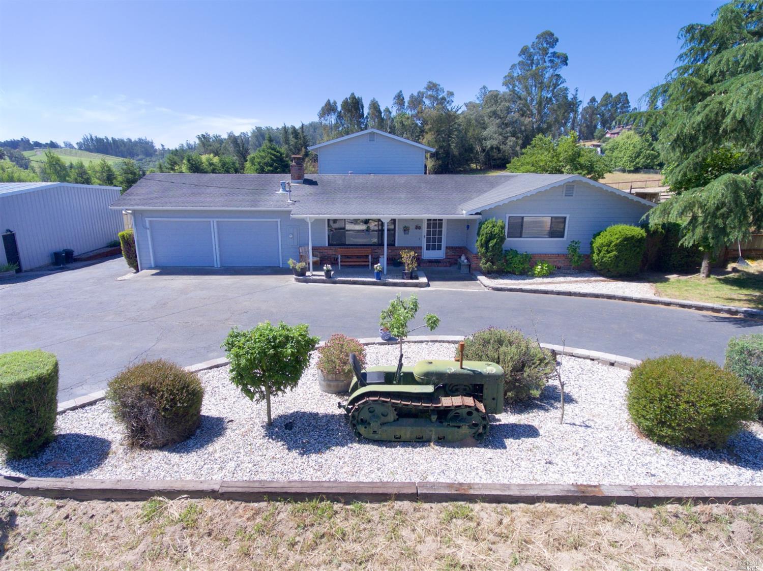 5771 Blank Road Sebastopol, CA 95472 - Photo 1 of 1 a front view of a house with a yard and outdoor seating