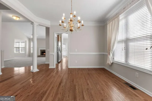a large kitchen with wooden floors and stainless steel appliances