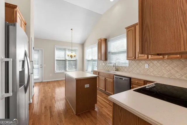 a kitchen with stainless steel appliances a refrigerator sink and cabinets
