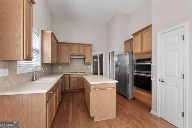 a view of an empty room with window and fireplace