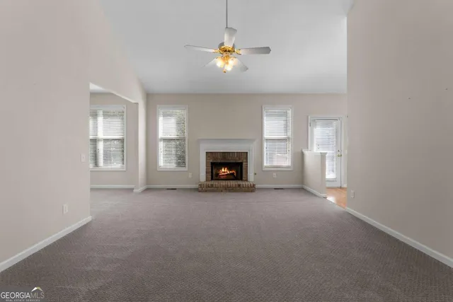a view of a livingroom with wooden floor and furniture